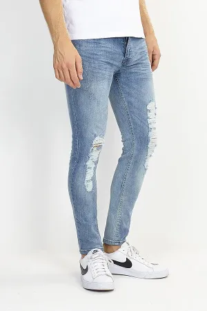 RIPPED LEG DISTRESSED BLUE SKINNY JEANS